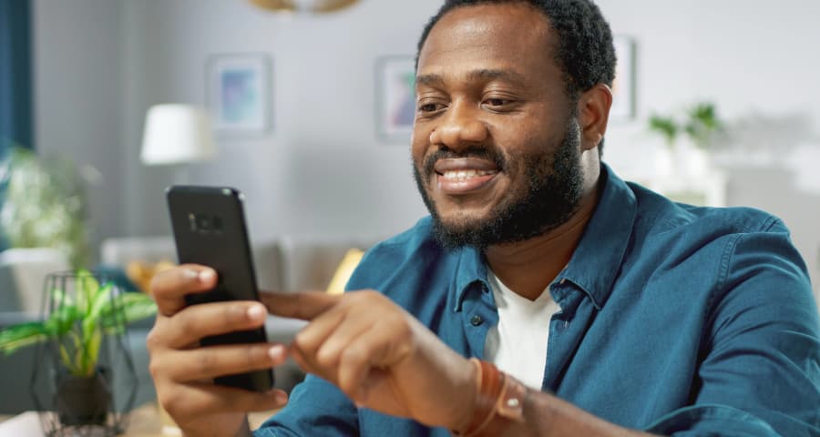 Man sitting down using an app on his smartphone